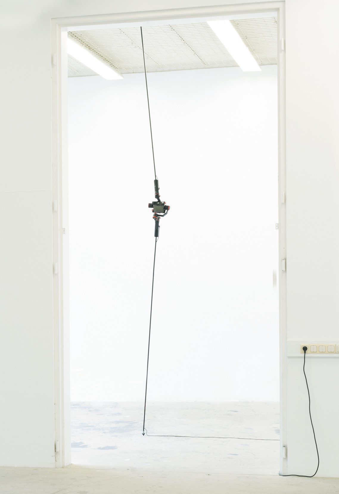 Two rods strung diagonally in a doorway, with a joint in the middle